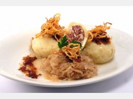 Stuffed Potato Dumplings with Smoked Meat, Sauerkraut and Fried Onions